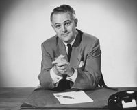 Portrait of a businessman sitting in an office poster print.