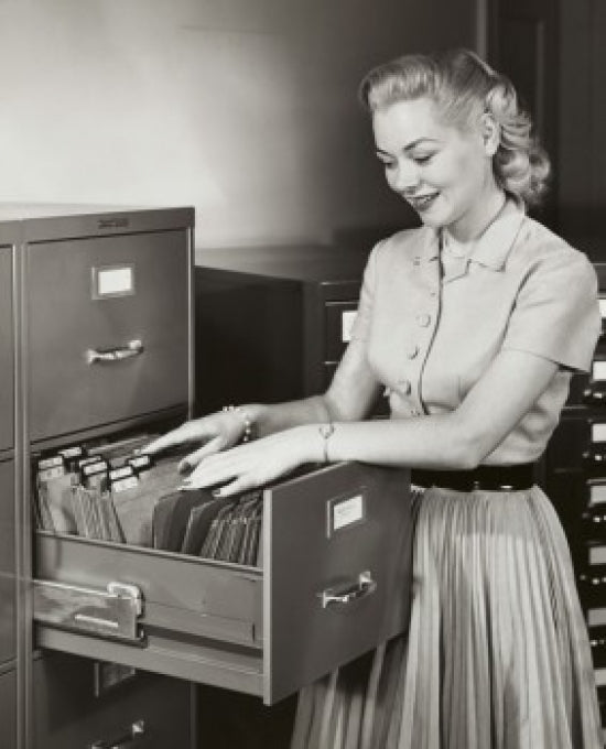 Businesswoman Searching for Files in a Filing Cabinet Poster Print