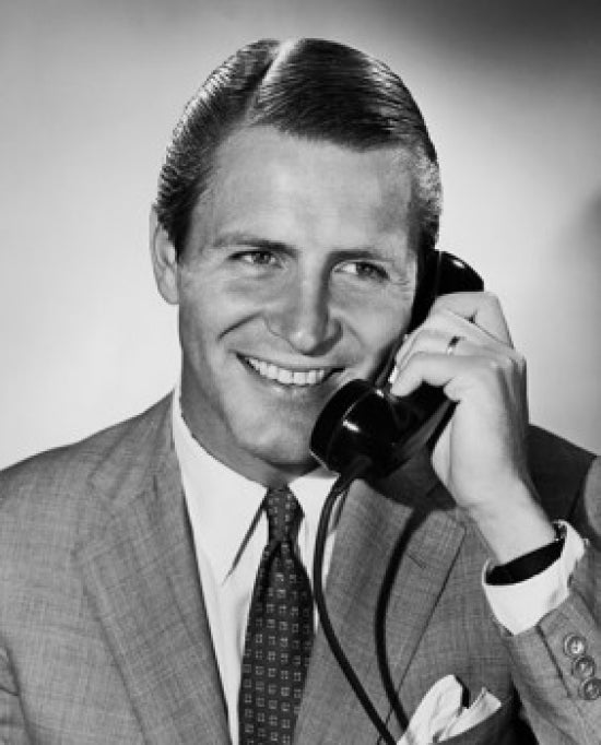 Close-up poster of a businessman talking on the telephone.