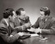 Close-up of three businessmen in a meeting poster print