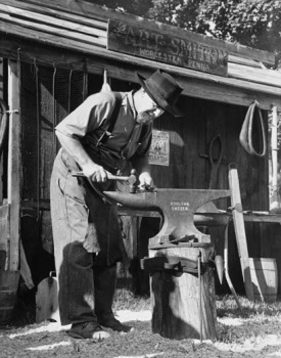 Amish blacksmith working on an anvil in Worcester, Pennsylvania poster print.