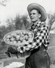 Mid adult man in profile holding a basket of apples poster print