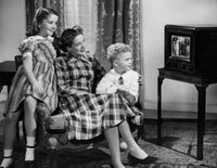 Poster print of a mid-adult woman with her son and daughter watching television.