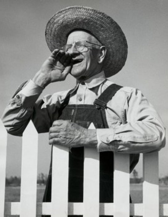 Close-up of a senior man standing near a picket fence poster print.
