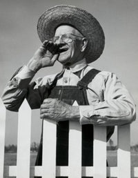 Close-up of a senior man standing near a picket fence poster print.