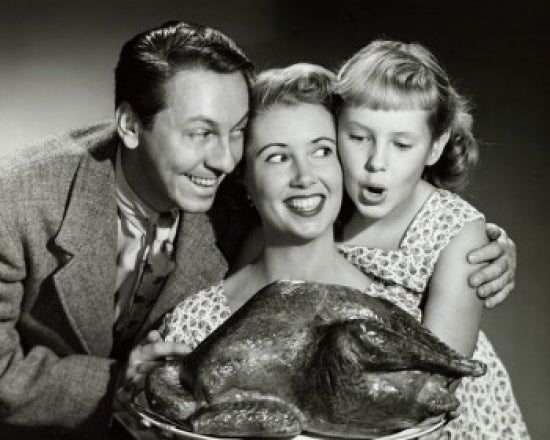 Family Gathering Poster Print featuring a family holding a turkey on a platter.