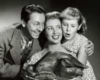 Family Gathering Poster Print featuring a family holding a turkey on a platter.