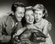 Family Gathering Poster Print featuring a family holding a turkey on a platter.