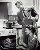 Parents and their son preparing a turkey in the kitchen poster print