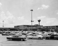 Cars parked in a shopping center, vibrant urban scene poster print.