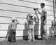 Poster print of a mature man with his two sons painting a wall together.