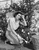 Young Woman Gardening Poster Print showcasing nature's beauty.