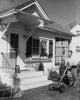 Young man mowing a front lawn poster print