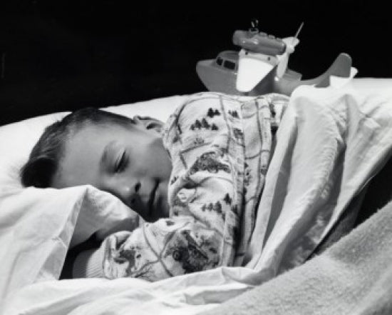 Close-up of a boy sleeping poster print showcasing the peacefulness of childhood.