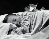 Close-up of a boy sleeping poster print showcasing the peacefulness of childhood.