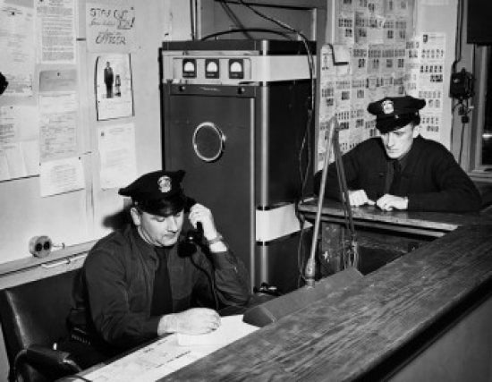 Two Policemen Working in Office Poster Print showcasing teamwork and dedication.