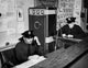 Two Policemen Working in Office Poster Print showcasing teamwork and dedication.