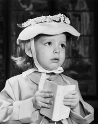 Close-up of a girl holding a book in church poster print.