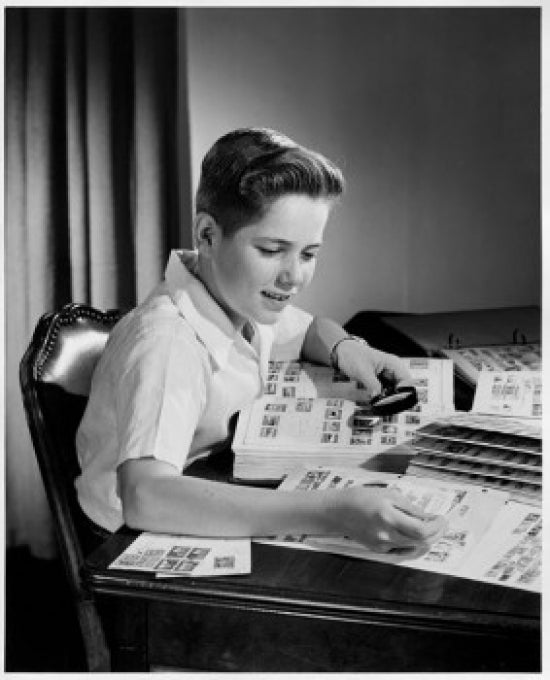 Boy Looking at Postage Stamps Through a Magnifying Glass Poster Print