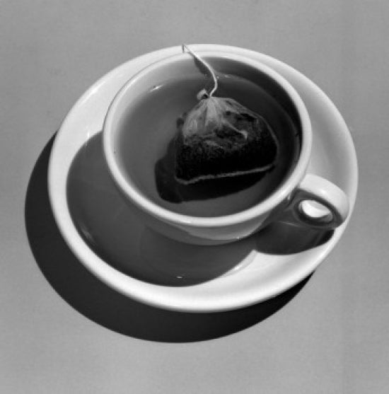 Cup of Tea Poster Print showcasing a serene tea moment, available in various sizes.