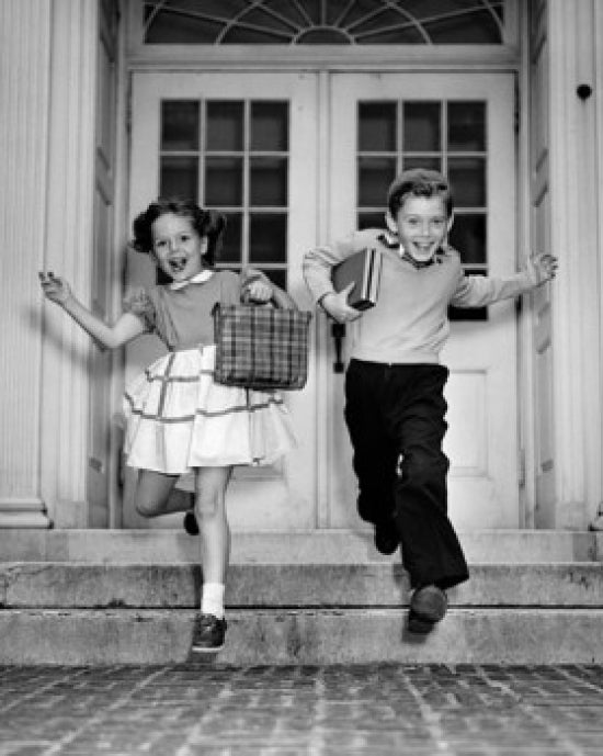 Schoolboy and schoolgirl jumping from steps poster print
