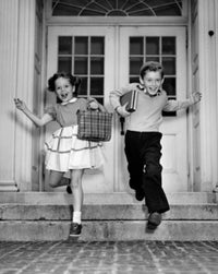 Schoolboy and schoolgirl jumping from steps poster print