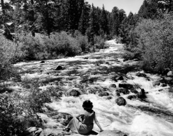 Photography poster print of a woman sitting by the Big Thompson River.