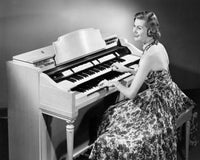 Side profile of a young woman playing an organ poster print.