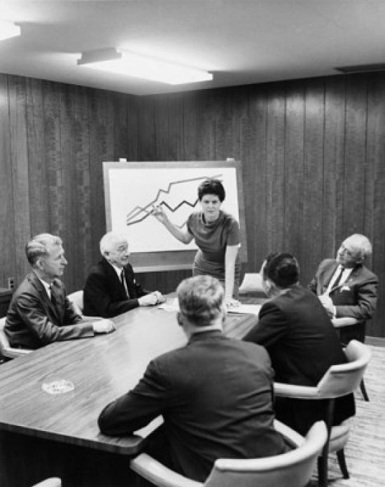 Businesswoman giving a presentation in a conference room poster print.