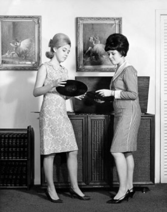 Poster print of two teenage girls side profile looking at vinyl records.