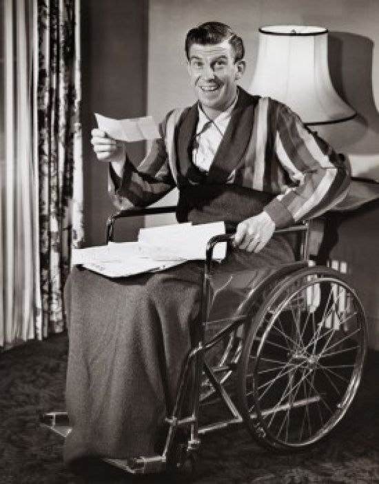 Uplifting portrait of a mature man in a wheelchair smiling.