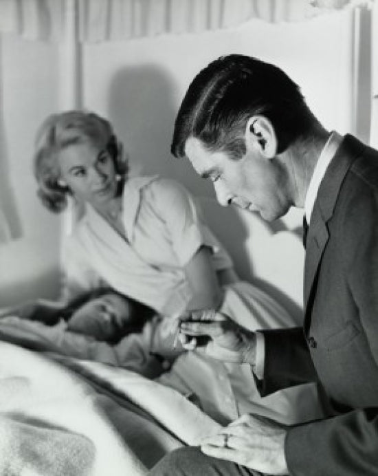 Male Doctor Reading a Thermometer Poster Print for medical decor.
