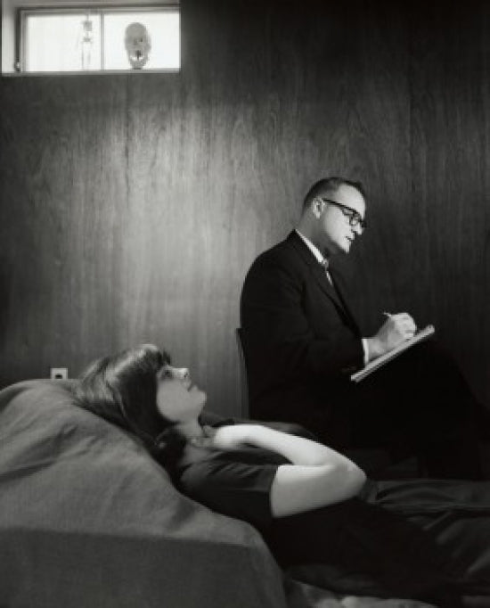 Psychologist writing on notepad after examining a female patient poster print.