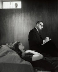 Psychologist writing on notepad after examining a female patient poster print.