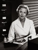 Portrait of a female nurse writing on a clipboard poster print.