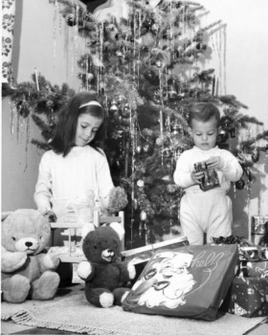 Christmas poster print featuring a girl with a doll and a boy opening a present.