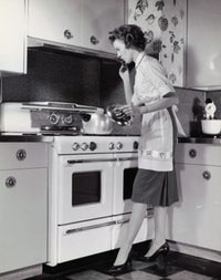 Mid adult woman cooking in the kitchen poster print