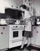 Mid adult woman cooking in the kitchen poster print