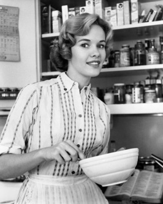 Young woman holding a bowl and smiling poster print.