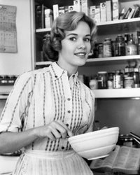Young woman holding a bowl and smiling poster print.