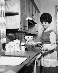 Young woman preparing food with a recipe book poster print