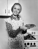 Charming poster of a mature woman smiling and holding a plate of food.