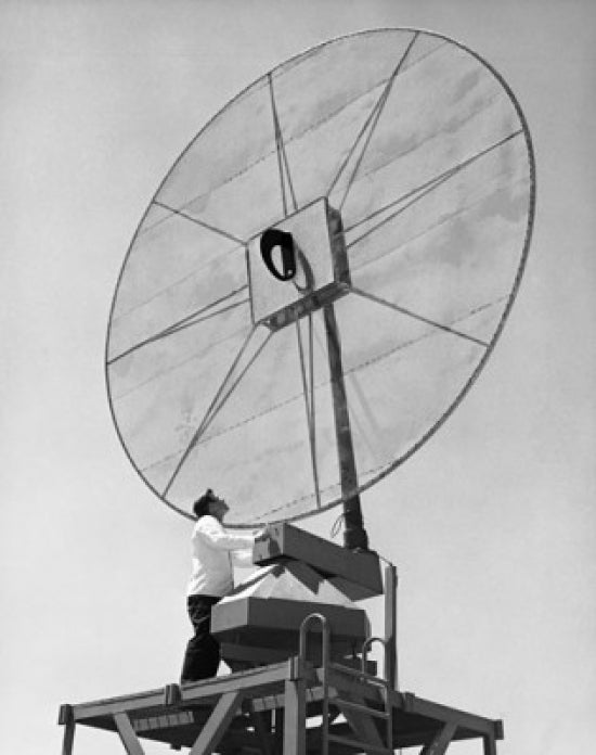Low angle view of an engineer in front of a Scimitar antenna poster print.