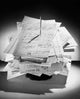 Close-up of receipts on a spike poster print showcasing intricate details.