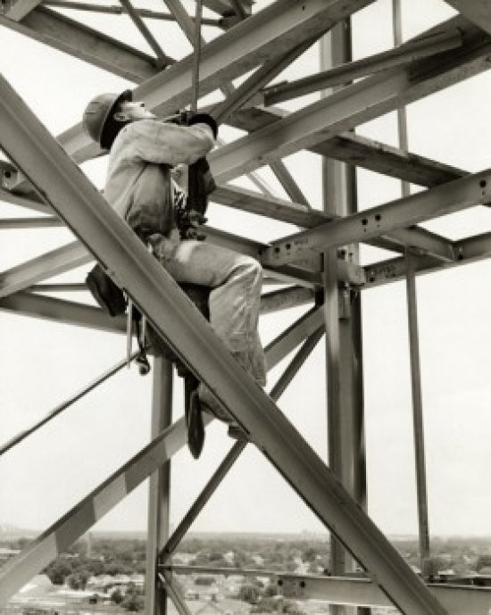 Poster print of a low angle view of a construction worker in a harness in New Orleans.