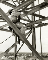 Poster print of a low angle view of a construction worker in a harness in New Orleans.