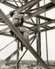 Poster print of a low angle view of a construction worker in a harness in New Orleans.