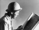 Side profile of a construction worker holding a blueprint poster print.