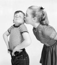 Studio shot of girl kissing boy poster print, romantic wall art.