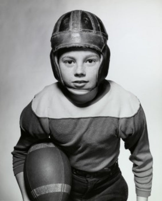 Close-up of a boy holding a football poster print
